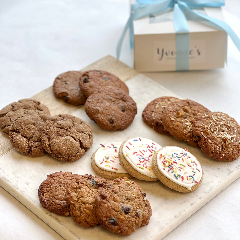 An assortment of cookies, including frosted with sprinkles, chocolate chip, and oatmeal raisin.