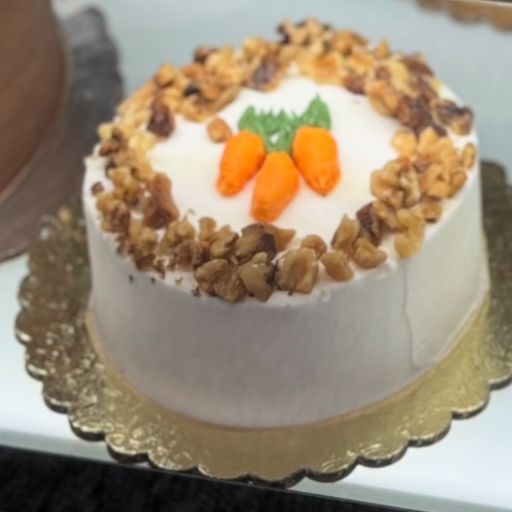 A 1-Layered Carrot Cake with Cream Cheese Frosting, walnuts, and carrot decor.