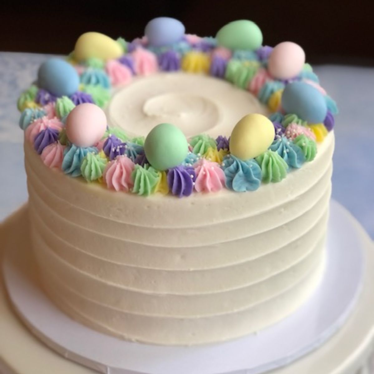 Spring Easter Egg Cake with pastel frosting and candy eggs.
